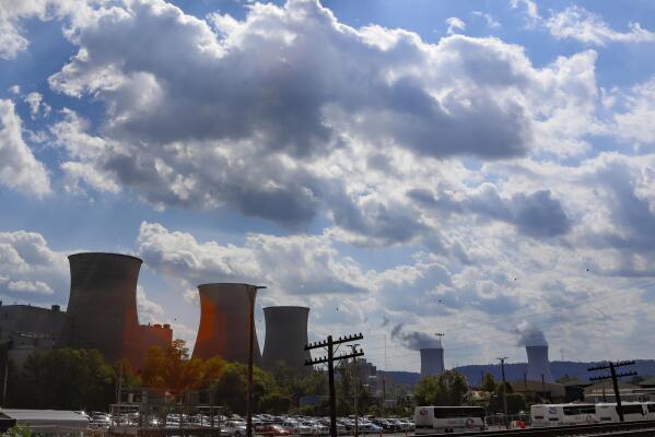 The Bruce Mansfield power plant in Shippingport, Pa., is seen from across the Ohio River from Industry, Pa. on Thursday, Oct. 3, 2019. Owners of coal-fired power plants, like the Bruce Mansfield plant that is scheduled to close next month, could pay more to emit carbon dioxide under Pennsylvania Gov. Tom Wolf's plan announced Thursday to bring Pennsylvania into a nine-state consortium that sets a price and limits on carbon dioxide emissions from power plants to help fight climate change.  (AP Photo/Keith Srakocic)