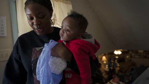 FILE - Ansonia Lyons holds her son, Adrian Lyons, as she takes him for a nappy change in Birmingham, Ala., Saturday, February 5, 2022. After two miscarriages, Ansonia became pregnant in 2020, and it was tough.  Doctors initially told her she had the usual morning sickness, even though she was vomiting blood.  Eventually, she was diagnosed with excessive vomiting disorder.  A study published Monday, July 3, 2023, in the Journal of the American Medical Association shows that maternal mortality rates in the United States doubled between 1999 and 2019, that Native Americans and Alaska Natives experienced the largest rate increase, and that black maternal mortality rates in general were the highest.  (AP Photo/Wong Maye-E, file)