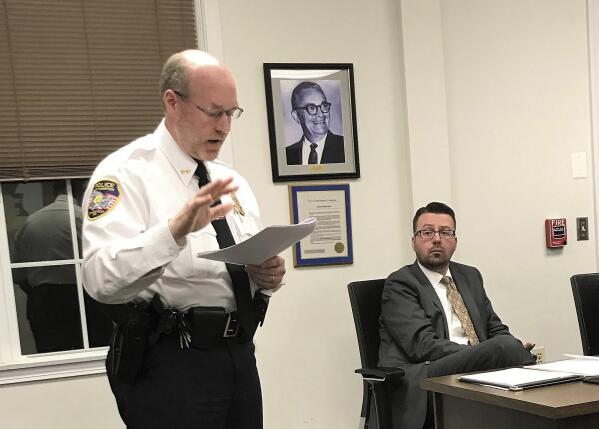 In this Nov. 14, 2018 photo, East Hampton, Conn., Police Chief Dennis Woessner addresses the Town Council in East Hampton. Chief Woessner has concluded that an officer's membership in a far-right group infamous for engaging in violent clashes at political rallies didn't violate any department policies. Woessner said that officer Kevin P. Wilcox is no longer associated with the Proud Boys group. (Jeff Mill/The Middletown Press via AP)