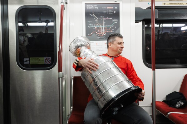 Former Toronto Maple Leafs hockey player Tomas Kaberle poses with the Stanley Cup on a subway car in Toronto, Monday, Jan. 22, 2024, to promote the NHL All-Star game Feb. 3. (Cole Burston/The Canadian Press via AP)