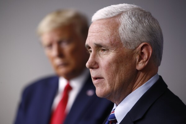 FILE - Vice President Mike Pence speaks alongside President Donald Trump during a coronavirus task force briefing at the White House in Washington on March 22, 2020. As Trump was being arraigned in Washington on yet another round of criminal charges, his former runningmate-turned-rival Mike Pence moved to capitalize on the news, unveiling merchandise that quoted from the indictment. “Too Honest” the shirts and hats read — a reference to Trump's response when Pence rebuffed his efforts to overturn the results of the 2020 election. (AP Photo/Patrick Semansky, File)