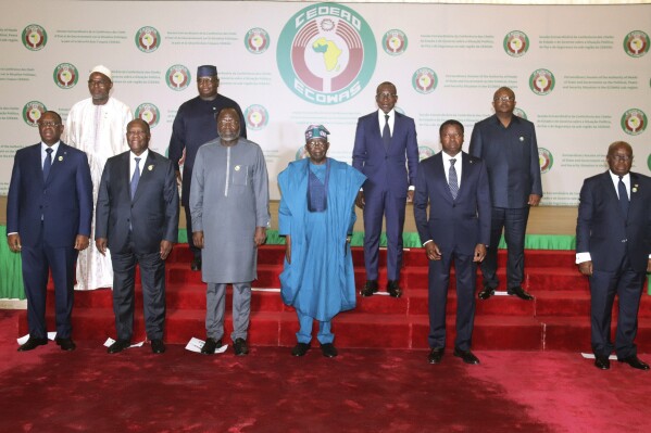 Nigeria's President, Bola Ahmed Tinubu, third from left, first row, poses for a group photo with other West African leaders, prior to the start of the ECOWAS meeting, in Abuja, Nigeria, Saturday, Feb. 24, 2024. Heads of state across West Africa were met on Saturday to discuss the region's existential challenges with a renewed plea on junta-led nations to rescind their decision to quit the regional bloc and a plan to review of sanctions it imposed to reverse the coup in Niger. (AP Photo/Gbemiga Olamikan)