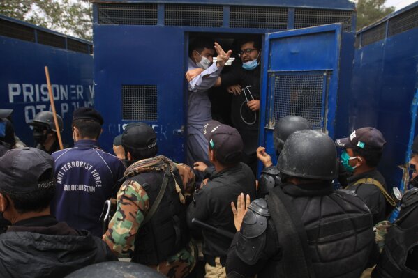 Police arrest doctors demanding facilities and prevention kits to attend to coronavirus patients, in Quetta, Pakistan, Monday, April 6, 2020. The government imposed a nationwide lockdown to try to contain the outbreak of the virus. (AP Photo/Arshad Butt)