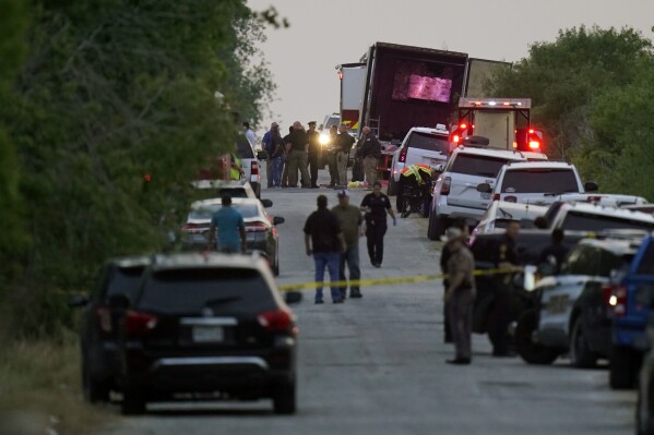 FILE - Police and other first responders work the scene where officials say dozens of people have been found dead and multiple others were taken to hospitals with heat-related illnesses after a tractor-trailer containing suspected migrants was found on June 27, 2022, in San Antonio. One of six men charged in Texas over 53 migrants who died last year in the sweltering tractor-trailer has pleaded guilty for his role in the nation's deadliest human smuggling attempt from Mexico, federal prosecutors said Wednesday, Sept. 27, 2023. (AP Photo/Eric Gay, File)