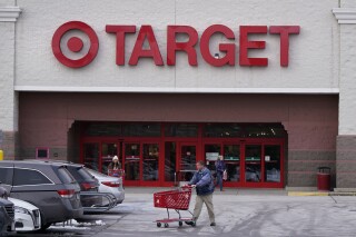 File - A shopper wheels a cart through the parking lot after making a purchase at the Target store, Monday, Feb. 27, 2023, in Salem, N.H. Target reports earnings on Wednesday, Nov. 15. (AP Photo/Charles Krupa, File)