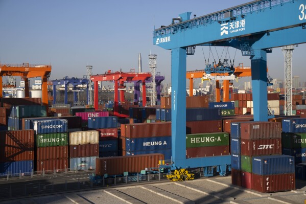 Shipping containers are stacked at a port in Tianjin, China, Monday, Jan. 16, 2023. China's exports tumbled 12.4% in June from a year earlier as demand weakened after central banks raised interest rates to curb inflation. (AP Photo/Mark Schiefelbein)