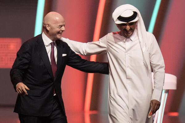 FILE - FIFA President Gianni Infantino, left, and Emir of Qatar Sheikh Tamim bin Hamad Al Thani leave the stage before the 2022 soccer World Cup draw at the Doha Exhibition and Convention Center in Doha, Qatar, Friday, April 1, 2022. The first World Cup in the Middle East is only one month away. Qatar has been on an often bumpy 12-year journey that has transformed the nation. (AP Photo/Hassan Ammar, File)