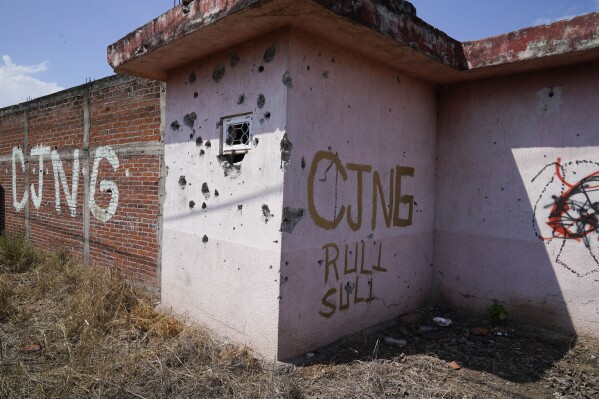 The letters "CJNG" which stands for "Jalisco New Generation Cartel" cover an abandoned home in El Limoncito, Michoacan state, Mexico, Oct. 30, 2021. (AP Photo/Eduardo Verdugo, File)