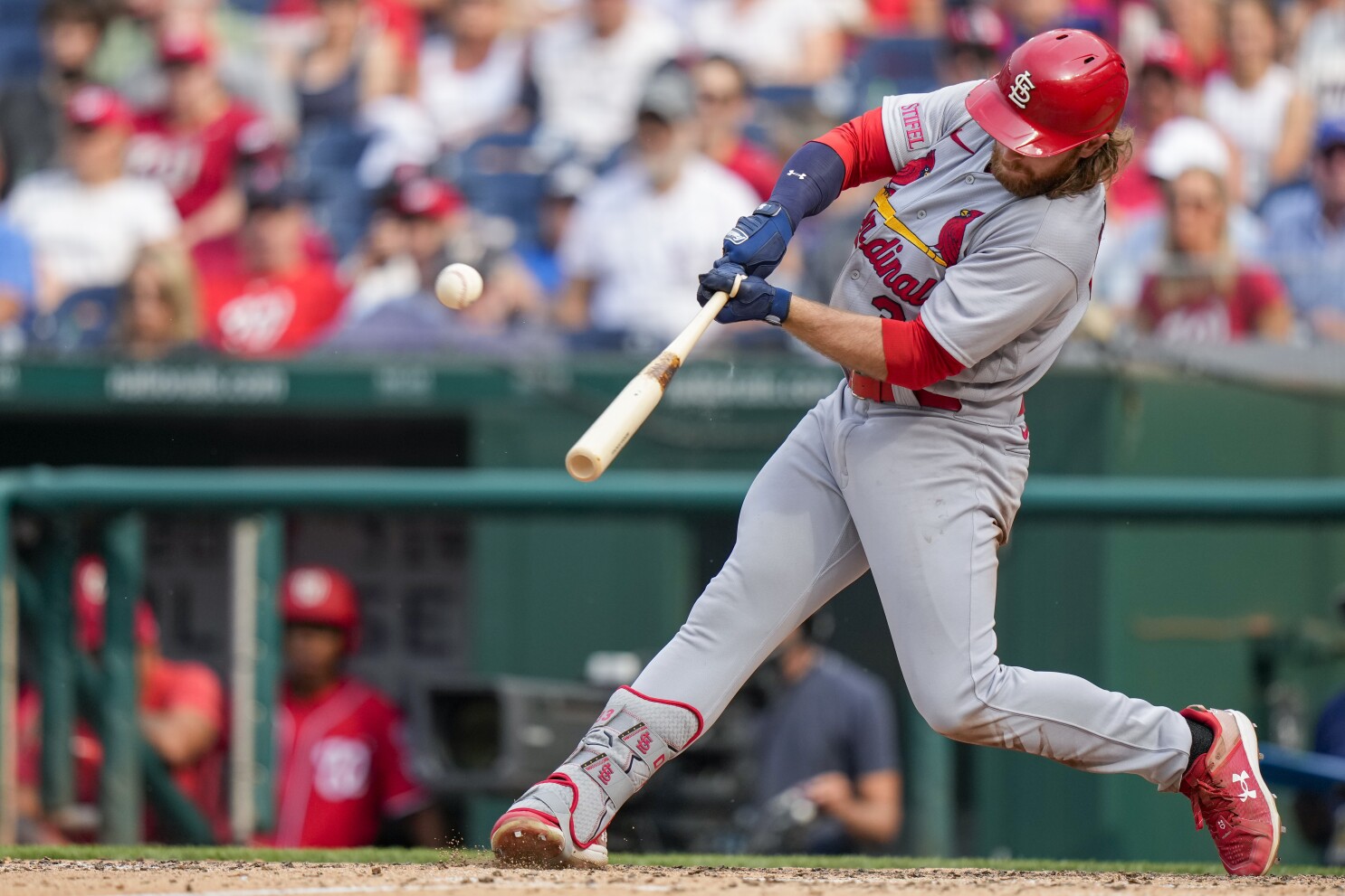 Nolan Gorman of the St. Louis Cardinals raises his bat as he runs