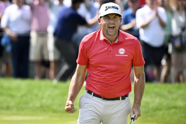 Keegan Bradley reacts to making birdie putt to a tie for the lead on the ninth hole during the final round of the Travelers Championship golf tournament at TPC River Highlands, Sunday, June 22, 2025, in Cromwell, Conn. (AP Photo/Jessica Hill)