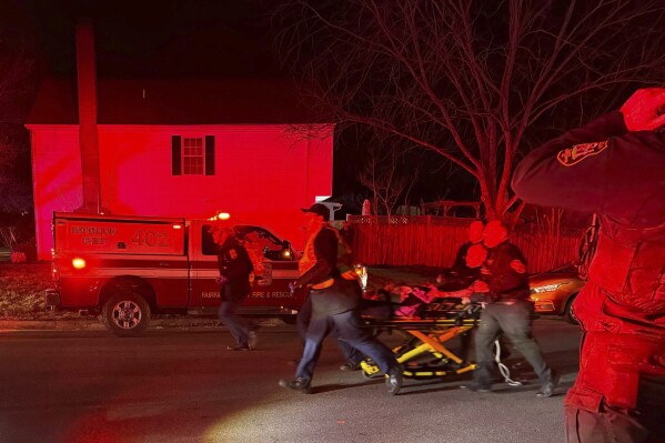 First responders carry an injured person away after an explosion at a home, late Friday, Feb. 16, 2024, in Sterling, Va. (Nicki Jhabvala/The Washington Post via AP)