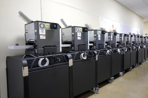 FILE - Affidavit printers are lined up at the Maricopa County Elections Department in Phoenix, Sept. 8, 2022. Big tech platforms say they are working hard to address misinformation about voting and elections ahead of the November midterms, but a look at their sites shows they are still struggling to contend with false claims from 2020. (AP Photo/Ross D. Franklin, File)