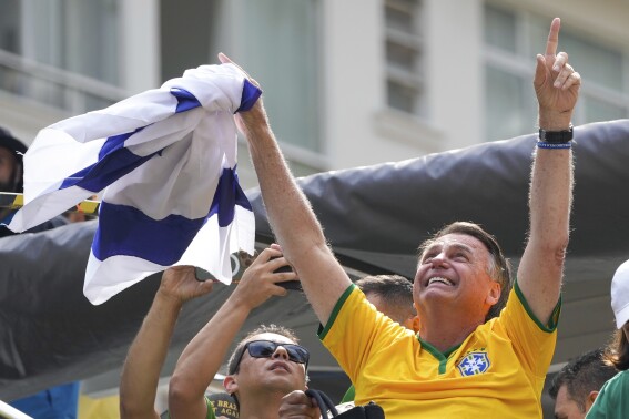 Former President Jair Bolsonaro addresses supporters during a rally in Sao Paulo., Brazil, Sunday, Feb. 25, 2024. Bolsonaro and some of his former top aides are under investigation into allegations they attempted plotted a coup to remove his successor, Luis Inacio Lula da Silva. (AP Photo/Andre Penner)