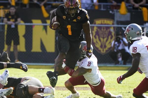 Washington State defensive back Armani Marsh (8) trips up Arizona State running back DeaMonte Trayanum (1) during the second half of an NCAA college football game, Saturday, Oct 30, 2021, in Tempe, Ariz. (AP Photo/Darryl Webb)