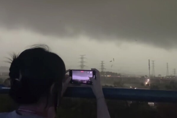 In this image taken from video and released by Li Jiayi, storm clouds and strong wind are seen over the Baiyun district in the southern Chinese's city of Guangzhou on April 27, 2024. A tornado struck the southern Chinese city of Guangzhou on Saturday, killing some and damaging factory buildings, state media said. (Li Jiayi via AP)
