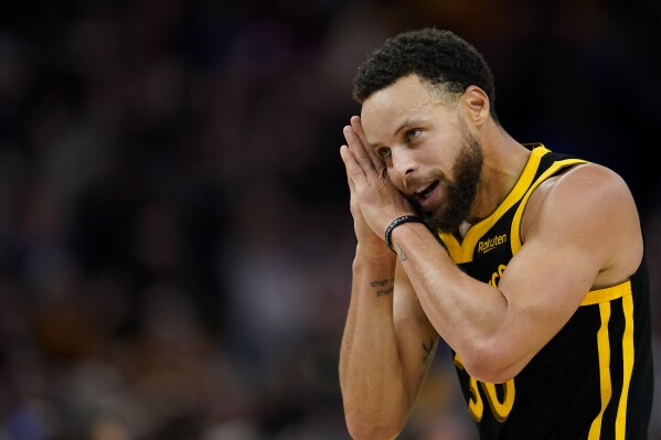 Golden State Warriors guard Stephen Curry reacts after scoring a 3-point basket against the Boston Celtics during overtime of an NBA basketball game Tuesday, Dec. 19, 2023, in San Francisco. (AP Photo/Godofredo A. Vásquez)