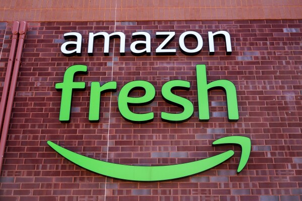FILE - An Amazon Fresh grocery store in Warrington, Pa., April 28, 2022. Amazon is cutting jobs in its Fresh Grocery stores as part of a restructuring plan in the U.S. The company confirmed Thursday, July 27, 2023 that its eliminating “zone lead” roles in its 44 Fresh Grocery stores. (AP Photo/Matt Rourke, file)