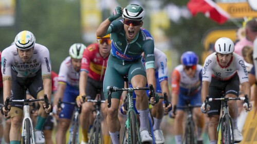 Belgium's Jasper Philipsen celebrates his fourth stage victory as he crosses the finish line ahead of Netherlands' Dylan Groenewegen, just behind Philipsen, and Germany's Phil Bauhaus, left, as he crosses the finish line to win the eleventh stage of the Tour de France cycling race over 180 kilometers (112 miles) with start in Clermont-Ferrand and finish in Moulins, France, Wednesday, July 12, 2023. (AP Photo/Thibault Camus)