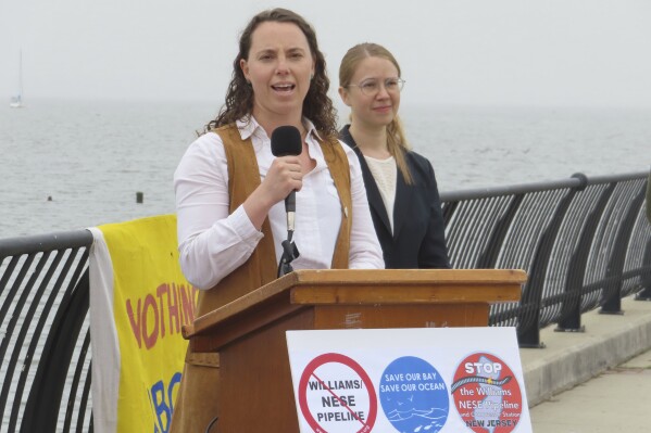 Taylor McFarland, a project manager with the Sierra Club speaks at a press conference in Keyport N.J., on Monday, May 6, 2024, to celebrate the cancellation of a natural gas pipeline project that would have run through the bay en route to New York City. But a different project to carry liquefied natural gas through Pennsylvania and New Jersey for export to other nations is moving forward. (AP Photo/Wayne Parry)