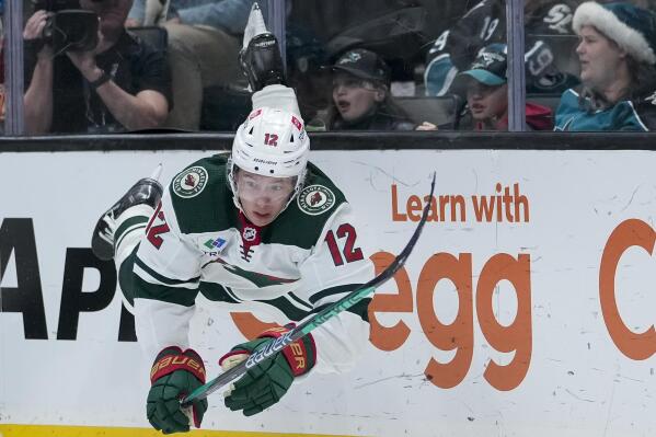 Minnesota Wild left wing Matt Boldy falls after passing the puck during the third period of the team's NHL hockey game against the San Jose Sharks in San Jose, Calif., Thursday, Dec. 22, 2022. (AP Photo/Godofredo A. Vásquez)