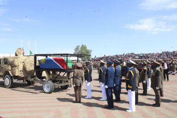 Mourners follow the flag-draped coffin of the late Namibian President Hage Geingob during his funeral service in Windhoek, Namibia, Sunday, Feb. 25, 2024. (AP Photo/Esther Mbathera)