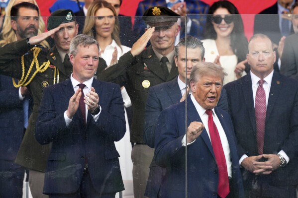 President Donald Trump arrives for a military parade commemorating the Army's 250th anniversary, coinciding with his 79th birthday, Saturday, June 14, 2025, in Washington, as Secretary of the Army Daniel Driscoll and Defense Secretary Pete Hegseth watch. (AP Photo/Julia Demaree Nikhinson)