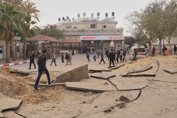 Palestinians inspect the site of an Israeli army airstrike on the European hospital in Khan Younis, Gaza Strip, Tuesday, May 13, 2025. The Israeli military said it had carried out a strike targeting what it said was a Hamas "command and control center" located beneath the hospital. (AP Photo/Mariam Dagga)