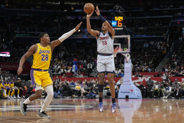 Washington Wizards guard Jordan Poole (13) shoots the ball against Los Angeles Lakers forward Rui Hachimura (28) during the first half of an NBA basketball game Thursday, Jan. 30, 2025, in Washington. (AP Photo/Jess Rapfogel)