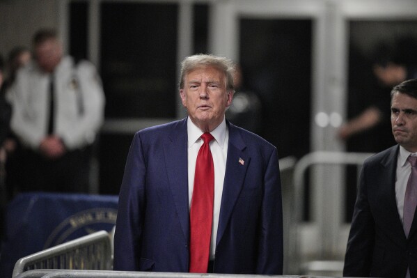 Former President Donald Trump speaks to the media outside the courtroom of his trial at Manhattan Criminal Court on Tuesday, April 30, 2024 in New York.  (Words by Curtis/Pool photo via AP)