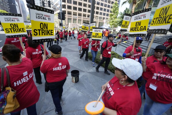 Striking hotel workers rally outside the Intercontinental Hotel after walking off their job early Sunday, July 2, 2023, in downtown Los Angeles. (AP Photo/Damian Dovarganes)
