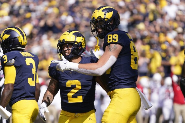 Michigan running back Blake Corum (2) celebrates his rushing touchdown with AJ Barner (89) against Rutgers in the second half of an NCAA college football game in Ann Arbor, Mich., Saturday, Sept. 23, 2023. (AP Photo/Paul Sancya)