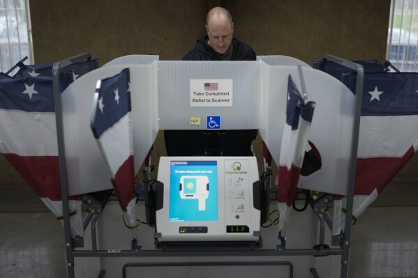 Doug Scopel votes a ballot at a polling place, Tuesday, March 5, 2024, in Nashville, Tenn. Super Tuesday elections are being held in 16 states and one territory. (AP Photo/George Walker IV)