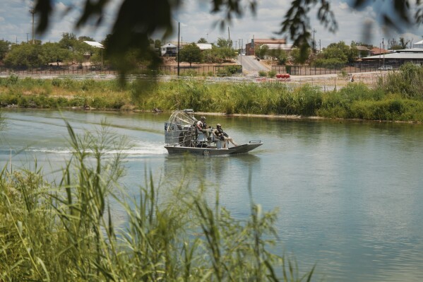 Florida State Troopers in an airboat patrol the Rio Grande in Eagle Pass, Texas, on Friday, Aug. 9, 2024. (Jordan Vonderhaar/The Texas Tribune via AP)