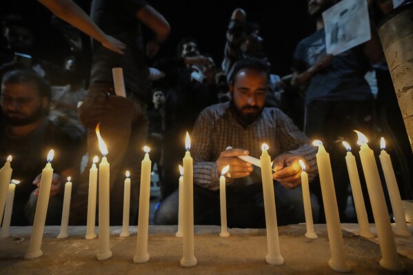 Shiite Muslim light candles in memory of Iranian President Ebrahim Raisi and others leaders during a vigil in Srinagar, Indian controlled Kashmir, Monday, May 20, 2024. Raisi and several other officials were found dead on Monday, hours after their helicopter crashed in a foggy, mountainous region of Iran's northwest, state media reported. (AP Photo/Mukhtar Khan)