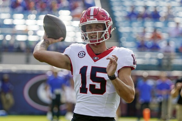 Georgia quarterback Carson Beck (15) warms up before an NCAA college football game against Florida, Saturday, Oct. 28, 2023, in Jacksonville, Fla. (AP Photo/John Raoux)
