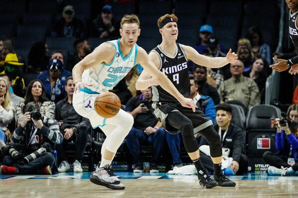 Charlotte Hornets forward Gordon Hayward, left, steals the ball from Sacramento Kings guard Kevin Huerter (9) during the first half of an NBA basketball game Monday, Oct. 31, 2022, in Charlotte, N.C. (AP Photo/Rusty Jones)