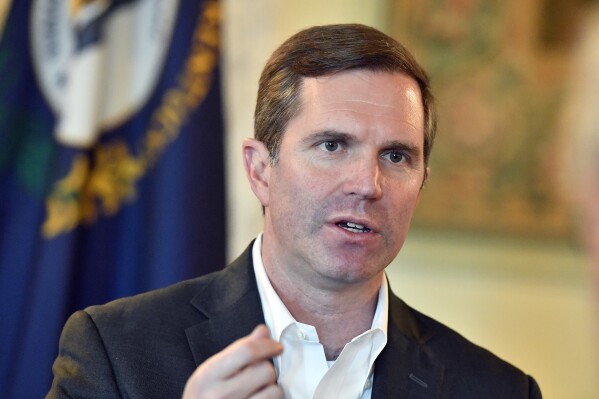 FILE - Kentucky Gov. Andy Beshear responds to a question during an interview, Dec. 19, 2023, in Frankfort, Ky. Kentucky will use a lottery system to award an initial round of licenses to businesses competing to participate in the state's startup medical cannabis program, Beshear announced Thursday, April 18, 2024. (AP Photo/Timothy D. Easley, File)