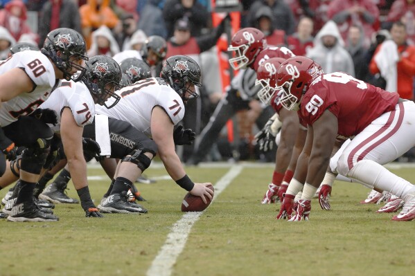 FILE - Oklahoma State, right, gets ready for a play against Oklahoma during the first half of an NCAA college football game, in Norman, Okla., Dec. 3, 2016. The 118th game between Oklahoma and Oklahoma State will be Nov. 4 in Stillwater, where the Cowboys won Bedlam two years ago to get into the Big 12 championship game. (AP Photo/Alonzo Adams, File)