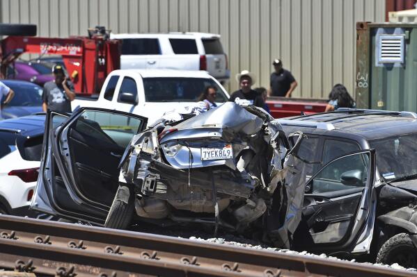 A vehicle is damaged after colliding with an Amtrak train in Brentwood, Calif., on Sunday, June 26, 2022. (Jose Carlos Fajardo/Bay Area News Group via AP)