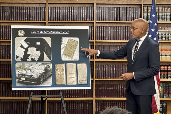 Damian Williams, U.S. Attorney for the Southern District of New York, talks about a display of photos of evidence in an indictment against Sen. Bob Menendez, D-N.J., during a news conference, Friday, Sept. 22, 2023, in New York. The sweeping bribery case brought against Menendez includes allegations that he took cash and gold in exchange for interfering in a criminal case against a New Jersey real estate developer.(AP Photo/Robert Bumsted)
