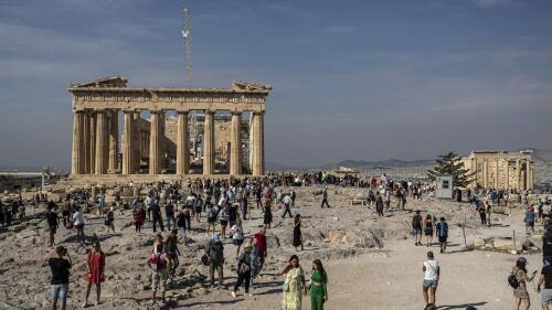 FILE - In this Tuesday, Oct. 11, 2022, file photo, tourists visit the Acropolis hill with the 2,500-year-old Parthenon temple on the left, and the ancient Erechtheion temple on the right, in Athens, Greece. Museums in Austria and Greece are discussing the potential return to Athens of two ancient Greek sculptures, announced on Tuesday, May 2, 2023, which could have a knock-on effect on the world's thorniest cultural heritage dispute — the fate of the British Museum's Parthenon Sculptures. (AP Photo/Petros Giannakouris, File)