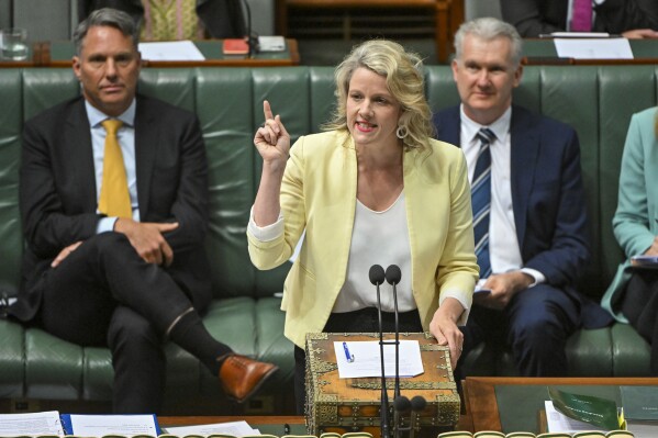 Australian Minister for Home Affairs Clare O'Neil gestures during question time in the House of Representatives at Parliament House in Canberra, Australia, Wednesday, Nov. 29, 2023. The Australian government on Wednesday proposed new laws that would place behind bars some of the 141 migrants who have been set free in the three weeks since the High Court ruled their indefinite detention was unconstitutional. (Mick Tsikas/AAP Image via AP)