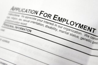 FILE - This April 22, 2014, file photo shows an employment application form on a table at a job fair in Hudson, N.Y. Middle-age white Americans with limited education are increasingly dying younger, on average, than other middle-age U.S. adults, a trend driven by their dwindling economic opportunities, research by two Princeton University economists has found. The economists, Anne Case and Angus Deaton, argue in a paper released Thursday, March 23, 2017, that the loss of steady middle-income jobs for those with high school degrees or less has triggered broad problems for this group. (AP Photo/Mike Groll, File)