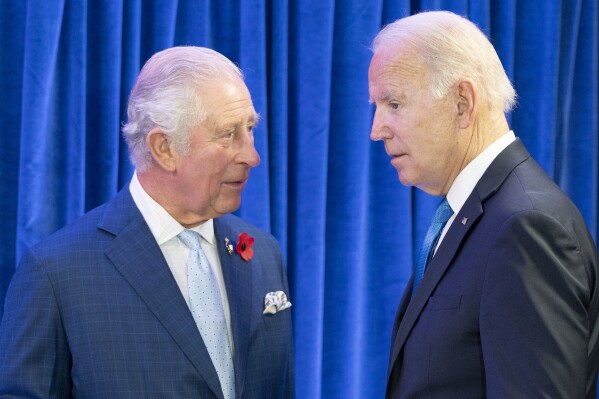 FILE - Britain's Prince Charles, left, greets the President of the United States Joe Biden ahead of their bilateral meeting during the Cop26 summit at the Scottish Event Campus (SEC) in Glasgow, Scotland, Nov. 2, 2021. Biden will spend four days in three nations next week as he travels through Europe tending to alliances that have been tested by Russia's invasion of Ukraine. His first stop is London, where he'll meet with King Charles III and Prime Minister Rishi Sunak. (Jane Barlow/Pool Photo via AP, File)