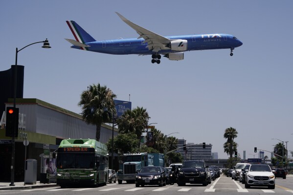 FILE - An ITA Airways passenger jet approaches to land at the Los Angeles International Airport in Los Angeles, on July 1, 2022. The European Commission on Tuesday announced an in-depth investigation of Lufthansa’s planned takeover of the Italian airline, ITA Airways, citing competitive concerns. Lufthansa last year signed a deal for a 41-percent minority share in the long-struggling ITA Airways, formerly Alitalia. (AP Photo/Jae C. Hong, File)