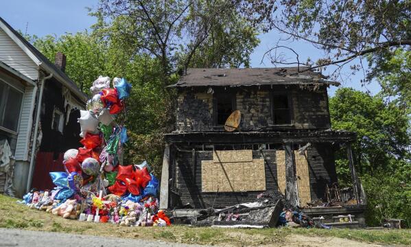FILE - In this Tuesday, May 23, 2017, file photo, a balloon memorial sits outside the burnt home of a family that died in a fire in Akron, Ohio. Stanley Ford, convicted of killing nine people in arson fires in his neighborhood, was sentenced Tuesday, Oct. 26, 2021, to life in prison without parole for each death. (AP Photo/Dake Kang, File)