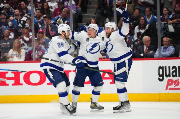Tampa Bay Lightning left wing Ondrej Palat (18) celebrates a goal against the Colorado Avalanche with Mikhail Sergachev (98) and Steven Stamkos (91) during the third period in Game 5 of the NHL hockey Stanley Cup Final, Friday, June 24, 2022, in Denver. (AP Photo/Jack Dempsey)