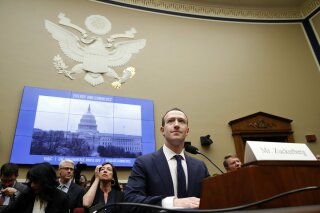 FILE - In this April 11, 2018 file photo, Facebook CEO Mark Zuckerberg returns after a break to continue testifying at a House Energy and Commerce hearing on Capitol Hill in Washington, about the use of Facebook data to target American voters in the 2016 election and data privacy. Facebook and other social platforms have been waging a fight against online misinformation and hate speech for two years. With the U.S. midterm elections coming soon on Tuesday, Nov. 6, there are signs that they're making some headway, although they're still a long way from winning the war. (AP Photo/Jacquelyn Martin, File)