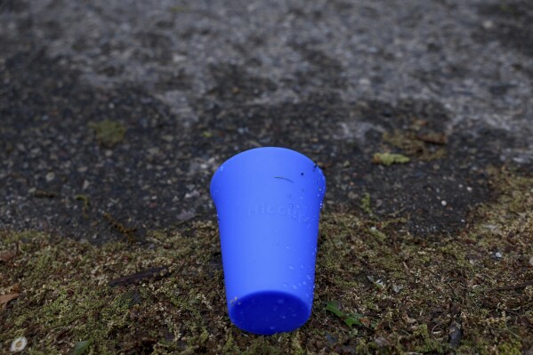 A used Hiccup, a reusable silicone cup, is discarded on the ground before being collected during the PNC Women Run the Cities race on Saturday, May 17, 2025, in Minneapolis. (AP Photo/Ellen Schmidt)