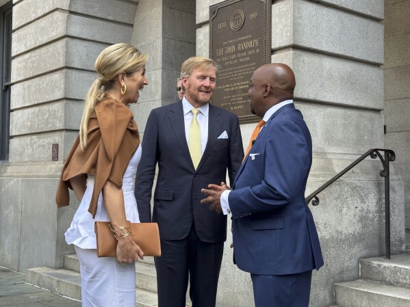 King Willem-Alexander, center, and Queen Maxima of the Netherlands are greeted by Mayor Van Johnson in Savannah, Ga., on Tuesday, June 11, 2024. The Dutch royals are visiting Georgia and New York during four-day U.S. tour that mixes stops at cultural sites with meetings focused on strengthening economic ties. (AP Photo/Russ Bynum)